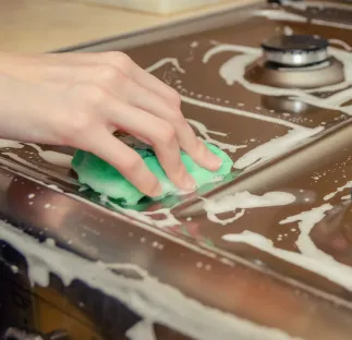 Cleaning a stovetop.